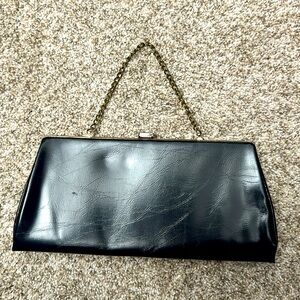 Vintage midnight navy trapezoid clutch with gold hardware and kiss-lock closure